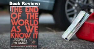 Hardcopy version of The End of the World as We Know It standing next to a folded paper map and gas can on the pavement next to a car.